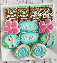 some decorated cookies are on a plate with the words mama maana and two flamingos