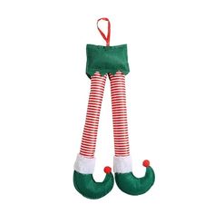 a green christmas stocking with red and white striped stockings hanging from it's side