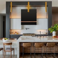 a large kitchen with an island counter and bar stools