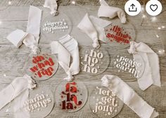 christmas ornaments on a wooden table with white ribbon and red lettering that says merry christmas