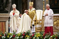 the pope is being ordained by two other priests