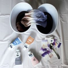 the contents of a white cup on a table with some cloths and other items