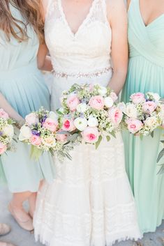 four bridesmaids in mint green dresses holding bouquets