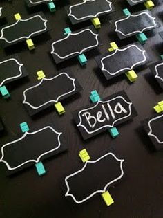 several pieces of black paper with yellow and green sticky notes attached to them that spell out the word bella