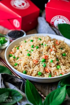 a bowl filled with rice and peas on top of a table