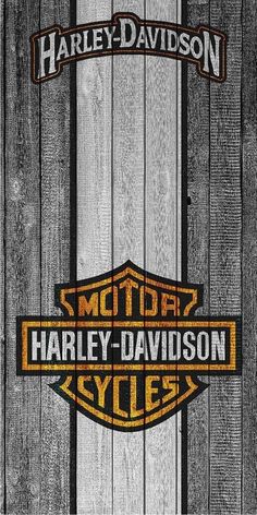 the harley davidson logo is shown on a wooden background with black and yellow stripes,