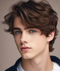 a young man with blue eyes wearing a sweater