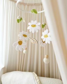 a baby crib with flowers hanging from it