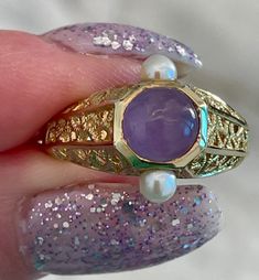 This is a unique 7 mm lavender jade in 14 kt yellow gold with two small pearls 💜 Size 6 1/2 Free Shipping  Free resizing  You will be of the unique design of this ring 💜 Pearl Gold Ring, Lavender Jade, Etsy Gold Ring, Pearl Size, Rings Statement, Gold Ring, Statement Rings, Jade, Gold Rings