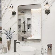 a bathroom with marble counter tops and white walls, including a large mirror over the sink