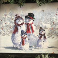 three snowmen standing next to each other in front of a snowy forest with christmas trees