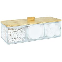 a clear box with white plates and chopsticks in it on a wooden table