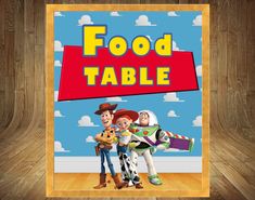 a poster with the words food table and two toy story characters in front of a wooden background