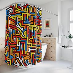 a colorful shower curtain in a bathroom with white walls and floor, along with a bathtub