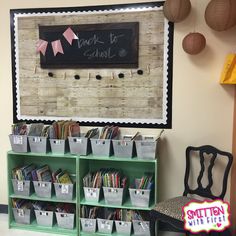 there is a chalkboard on the wall and some books in bins next to it