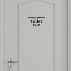 a white door with the words toilet on it