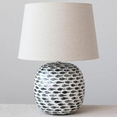 a white and black lamp on a table