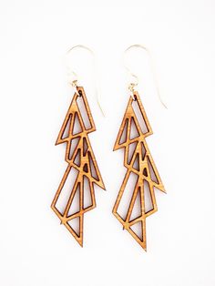 Four overlapping triangles form this eye catching geometric pattern that is unique, modern, and a little bit rock start. Bamboo with gold filled hardware. Includes gift packaging. Laser Cut Wood Earrings, Laser Ideas, Laser Cut Earrings, Cut Earrings, Jewelry Workshop, 3d Laser