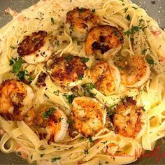 pasta with shrimp and parmesan cheese in a pan