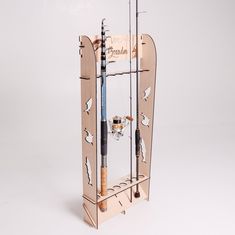 a wooden fishing rod holder with two rods in it and a glass on the bottom