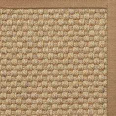 a close up view of the side of a rug with brown and tan woven material