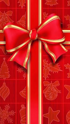 a red and gold christmas gift box with a big bow on it's side