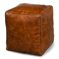 a brown leather cube ottoman sitting on top of a white floor