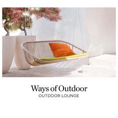 a hanging chair with an orange pillow on the bottom and green pillows on the top