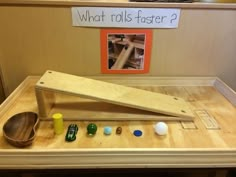 a wooden table topped with lots of different types of toys and items on top of it