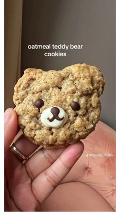 someone holding up a cookie with a teddy bear face on it and the caption reads, oatmeal teddy bear cookies