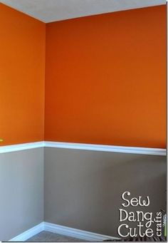 an empty room with orange walls and white trim