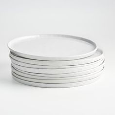 six white plates stacked on top of each other