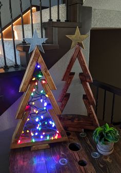 a wooden christmas tree sitting on top of a table