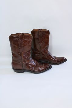 This is a pair of vintage leather cowboy boots. See last 2 photos for sole measurements.  Size: 10 1/2 Brand: Lucchese Materials: Leather Condition: Very good vintage condition - Some wear and scratches here and there, which adds to the worn-in feel. See photos for best description. Vintage Moc Toe Moto Boots For Fall, Fitted Vintage Boots With Goodyear Welted, Fitted Vintage Boots With Goodyear Welt, Vintage Goodyear Welted Boots For Fall, Vintage Goodyear Welted Boots With Almond Toe, Vintage Moto Boots With Goodyear Welt And Snip Toe, Classic Vintage Brown Boots For Western-themed Events, Vintage Snip Toe Ranch Boots, Vintage Goodyear Welted Ankle Boots