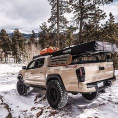 the truck is parked in the snow with its roof rack on it's back