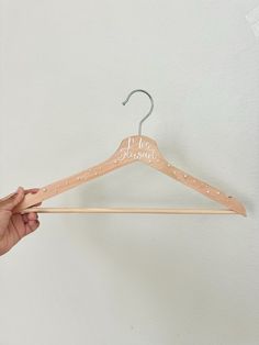 a person holding up a wooden hanger with the word, i'm not pregnant on it