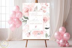 a baby shower sign with balloons in front of it and a bouquet of pink flowers