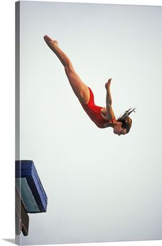 a woman in red swimsuit diving into the water