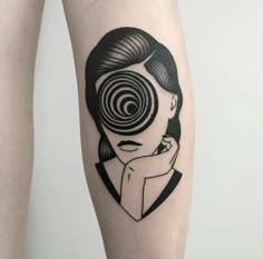 a woman's leg with a black and white image of a spiral design on it