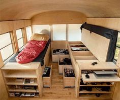 the inside of a camper with multiple drawers and storage compartments on each side of the bed