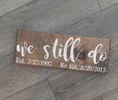 a wooden sign that says we still do