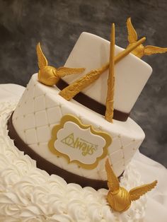 there is a wedding cake with gold birds on it