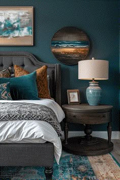 a bedroom with teal walls, blue carpet and bed in the center is a round mirror on the wall