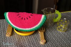 a crocheted watermelon pot holder sitting on top of a table