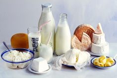 there are many different types of food on the table together, including milk and bread