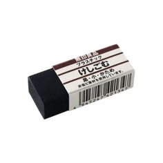 a black and white eraser sitting on top of a white surface next to a barcode