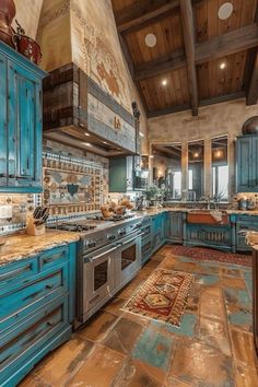 a large kitchen with blue cabinets and marble counter tops on the floor is pictured in this image