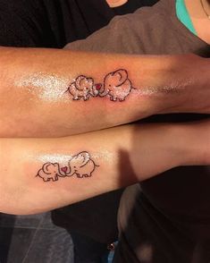 two people with matching tattoos on their legs, one has an elephant and the other has a sheep