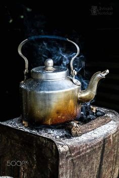 a tea kettle with steam coming out of it