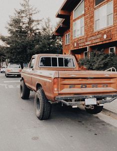 an old pick up truck parked in front of a building